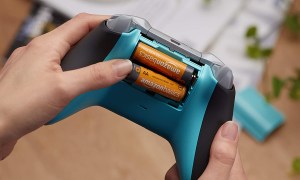 AmazonsBasics AA batteries being inserted into a game controller.