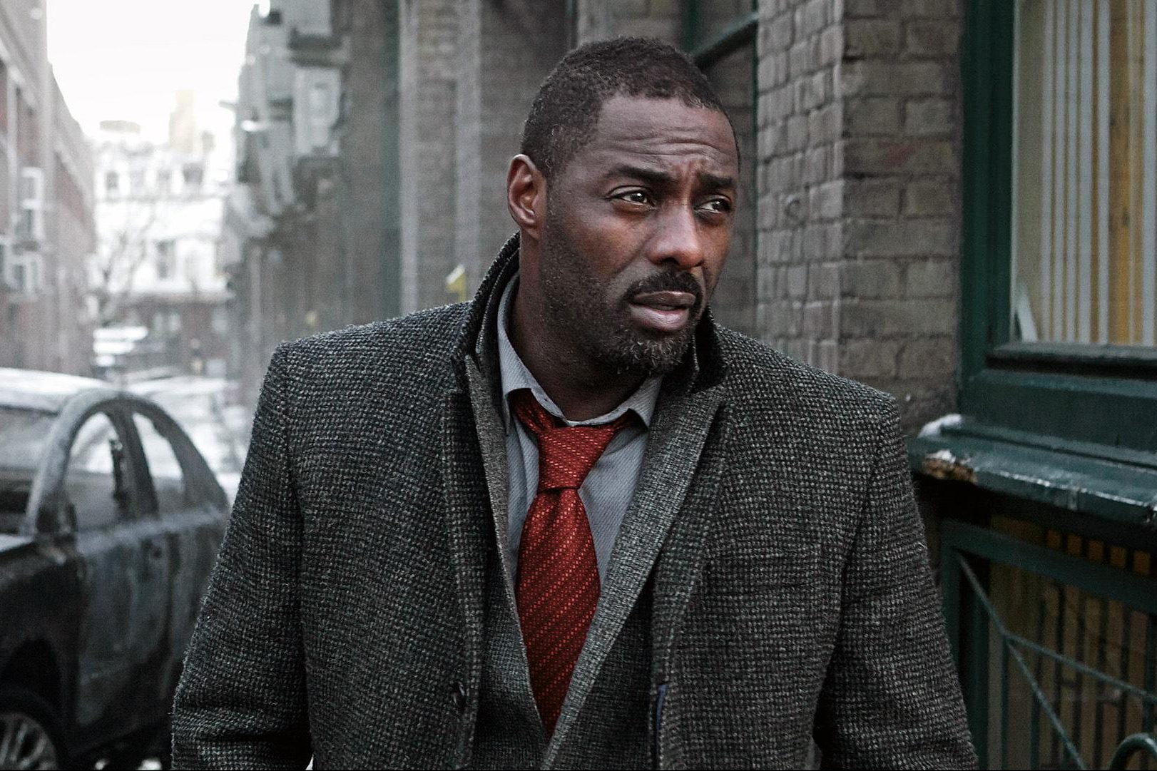 A man walks down an alley in Luther.