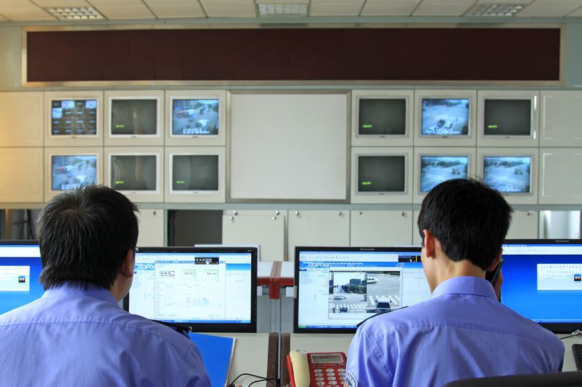 police surveillance tech center street screens on a wall