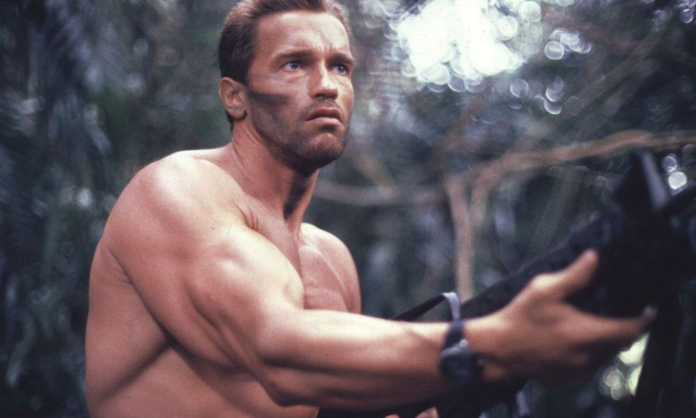 Arnold holds a machine gun in Predator.