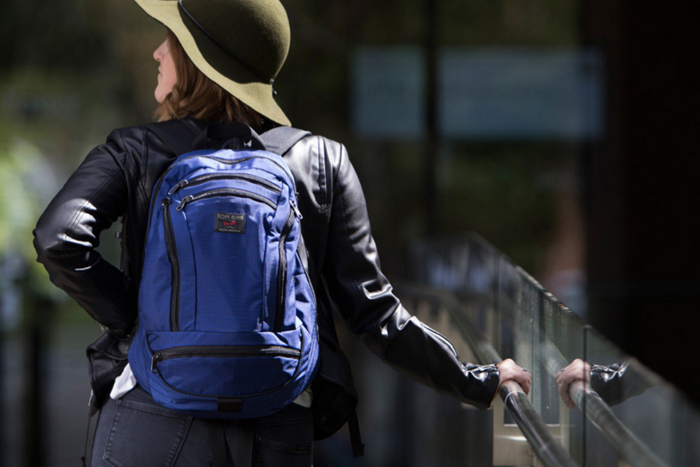 A person wearing a Tom Bihn Synapse 19 backpack.