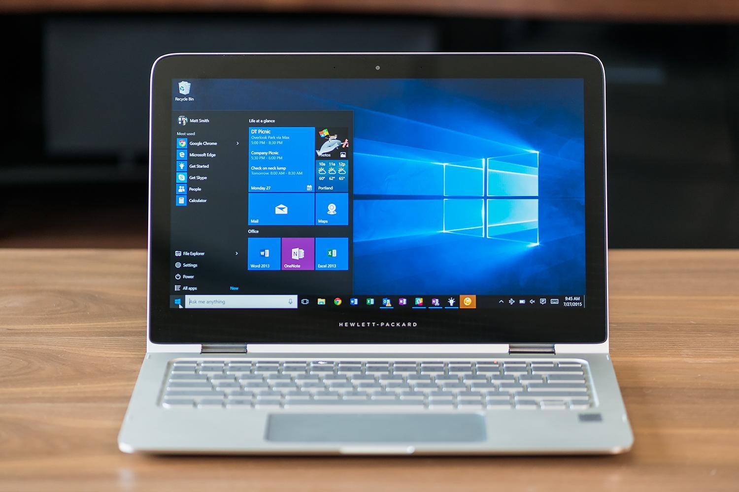 A Windows 10 laptop sitting atop a desk.