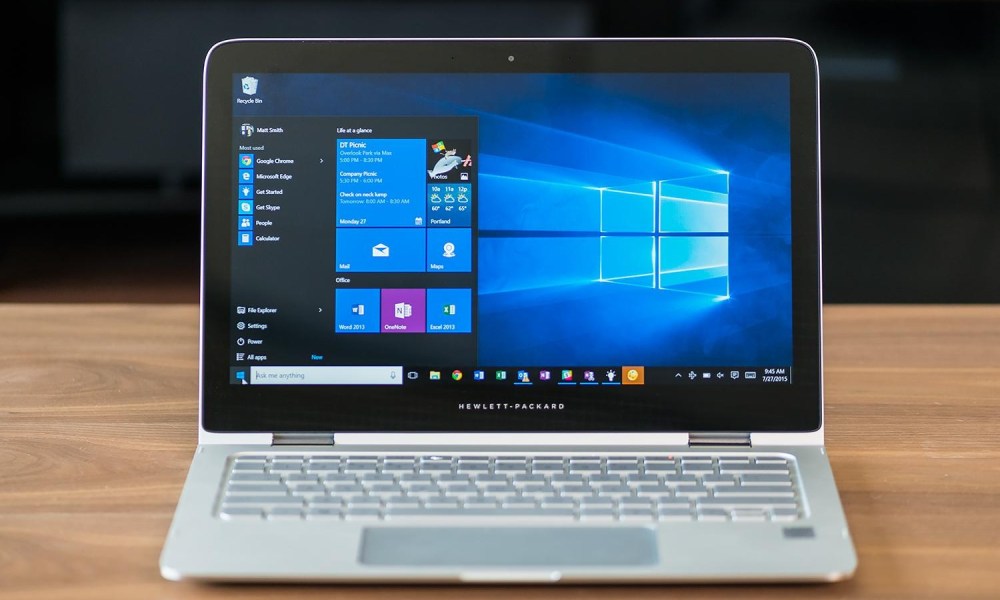 A Windows 10 laptop sitting atop a desk.