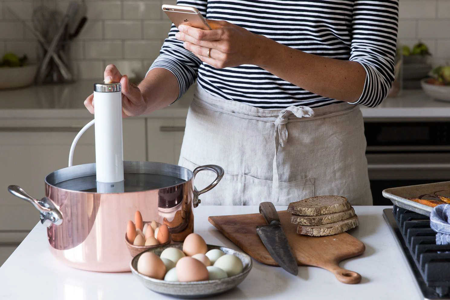 Woman using ChefSteps CS10001 Joule Sous Vide 