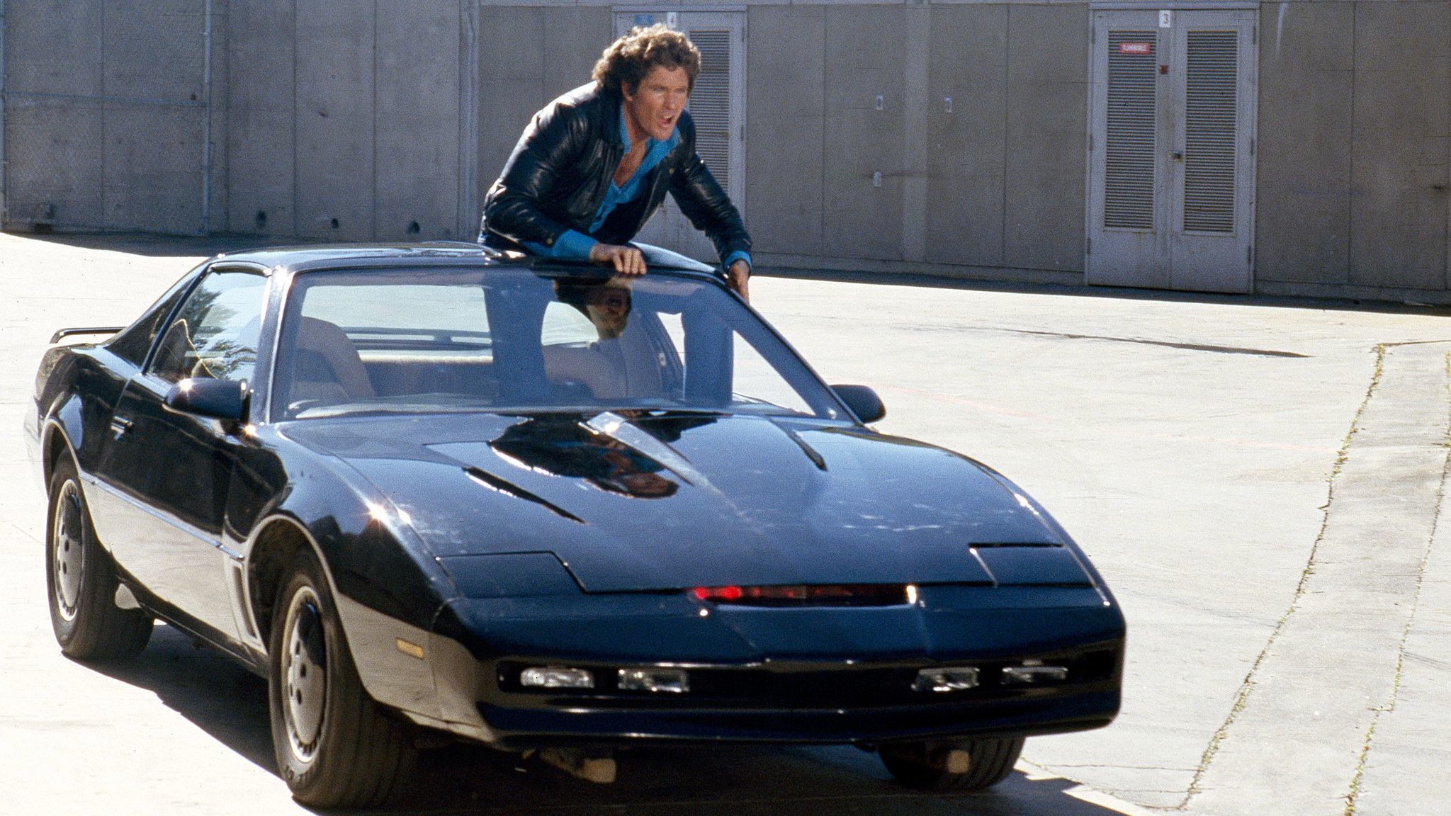 Michael Knight standing in KITT in the TV series Knight Rider.