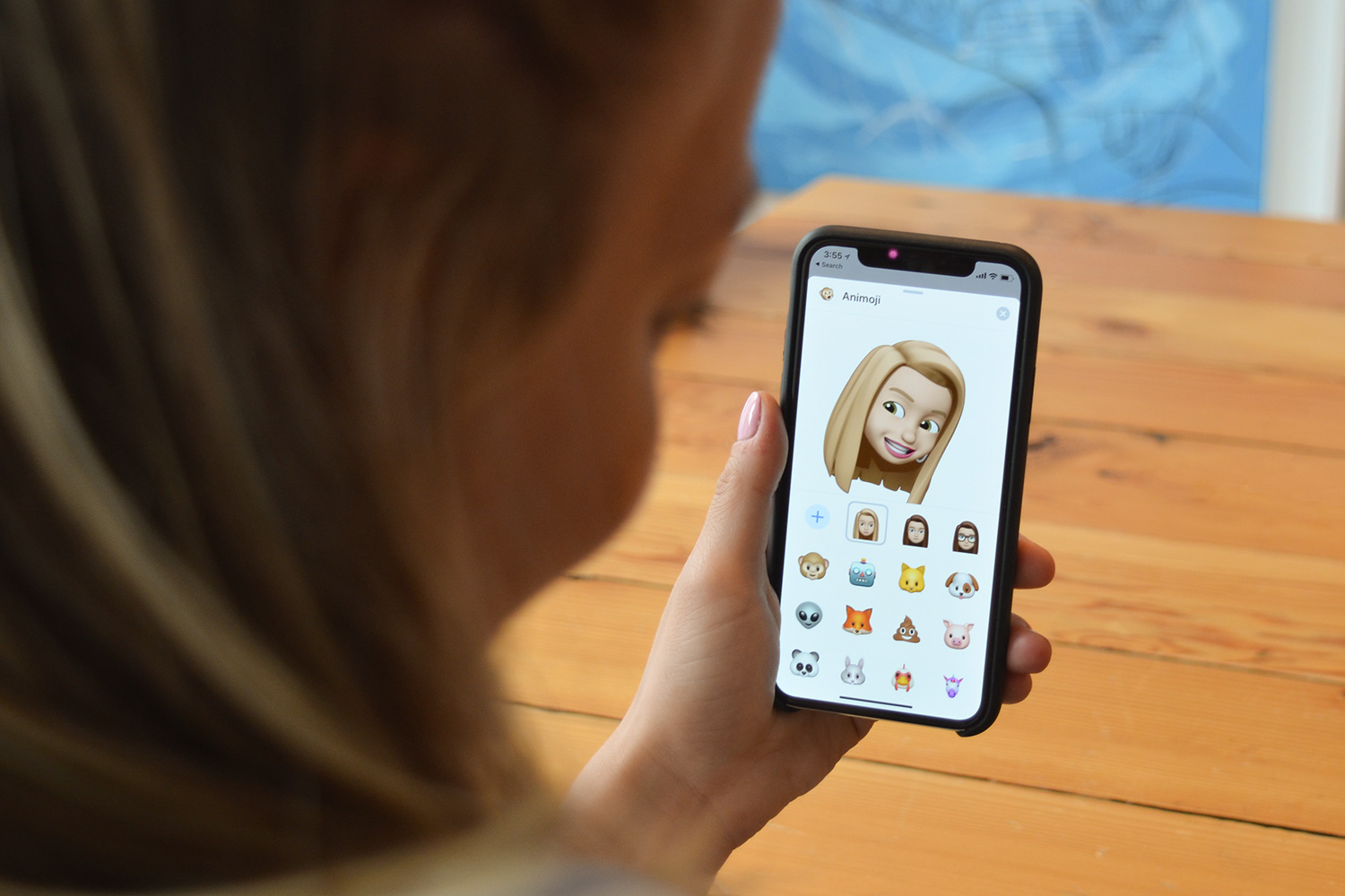 apple iphone 13 vs 12 memoji on in hand