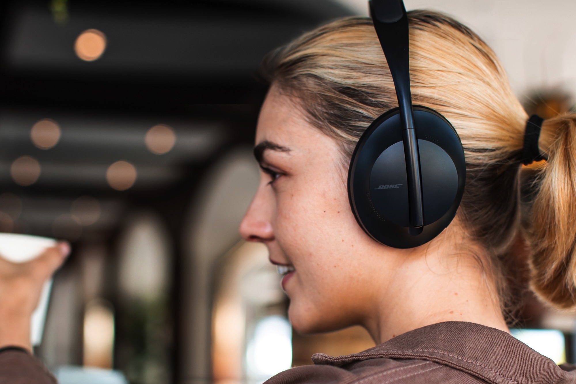 A woman wearing the Bose Noise Cancelling Headphones 700.