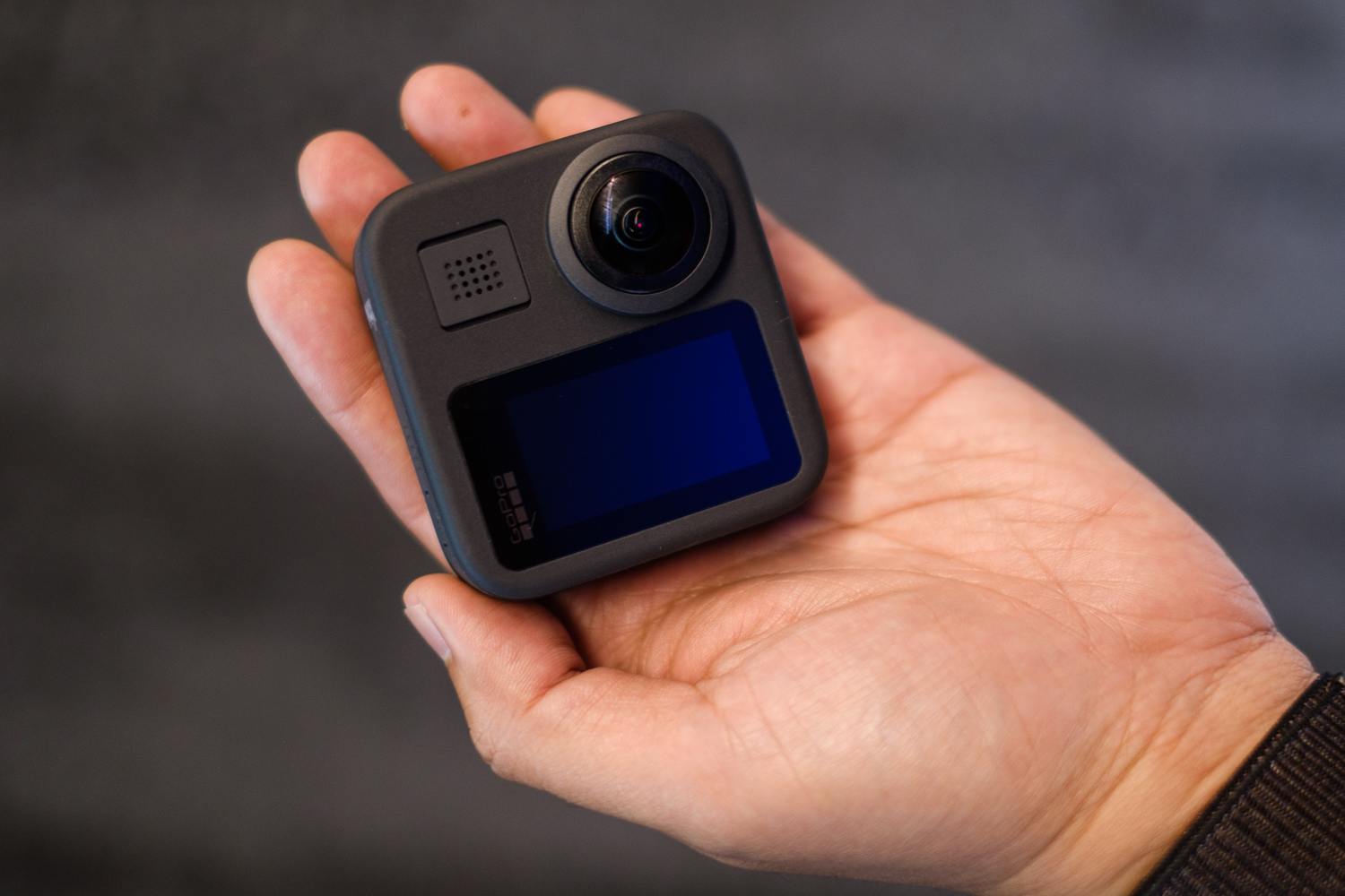 GoPro Max 360 camera in hand, back