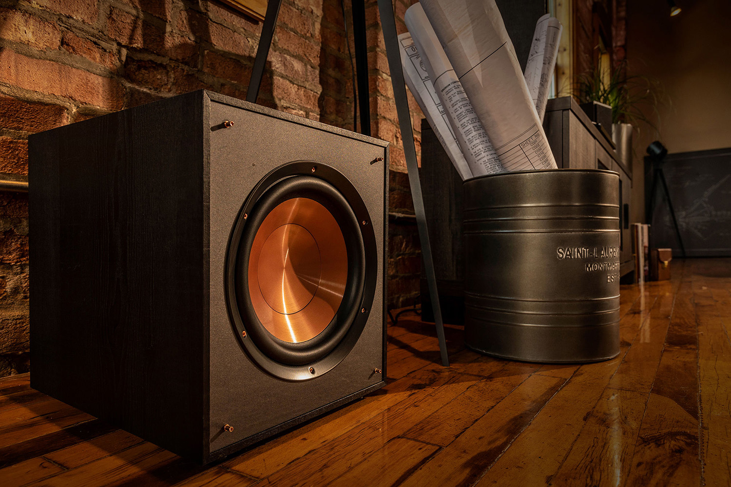 A Klipsch R-10SWi wireless subwoofer sits on a floor.