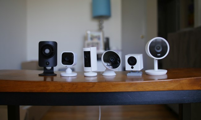 A table with six different security cameras on top of it.