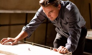 A man looks at a spinning top in Inception.