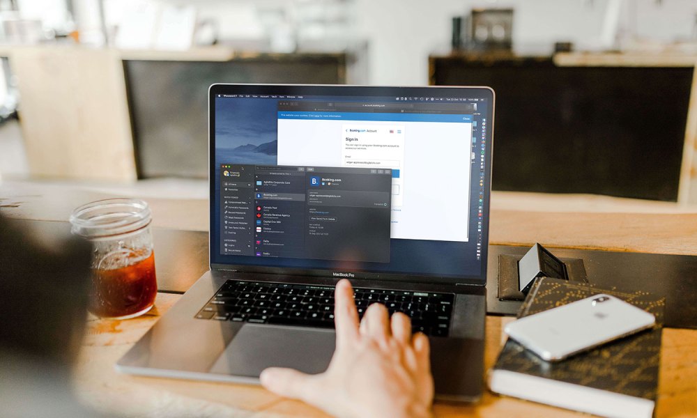 A person using 1Password on a MacBook.