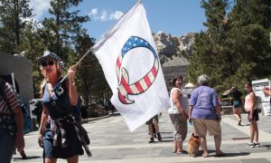 QAnon supporter with Q flag