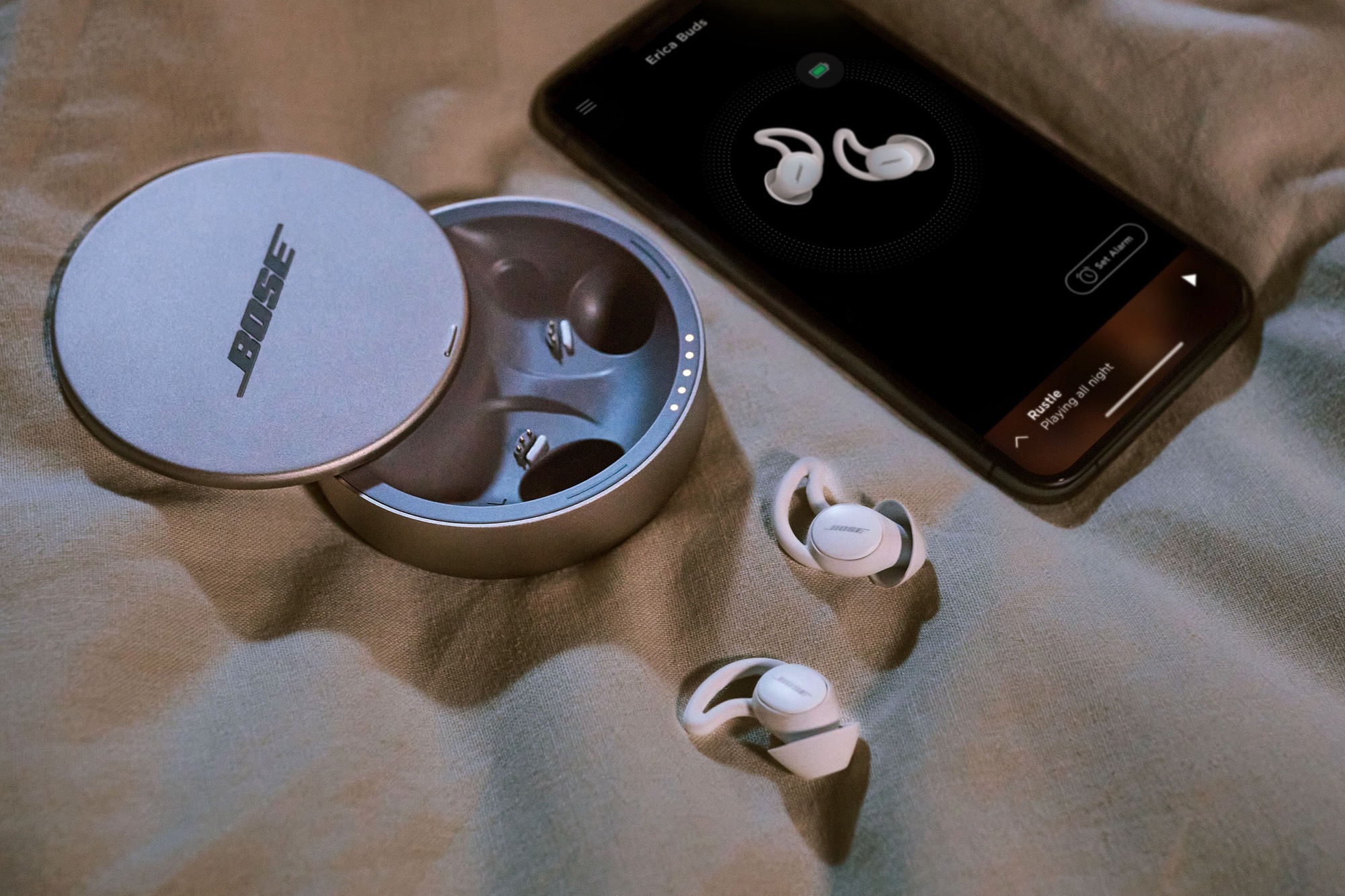 Bose Sleepbuds II next to a smartphone.