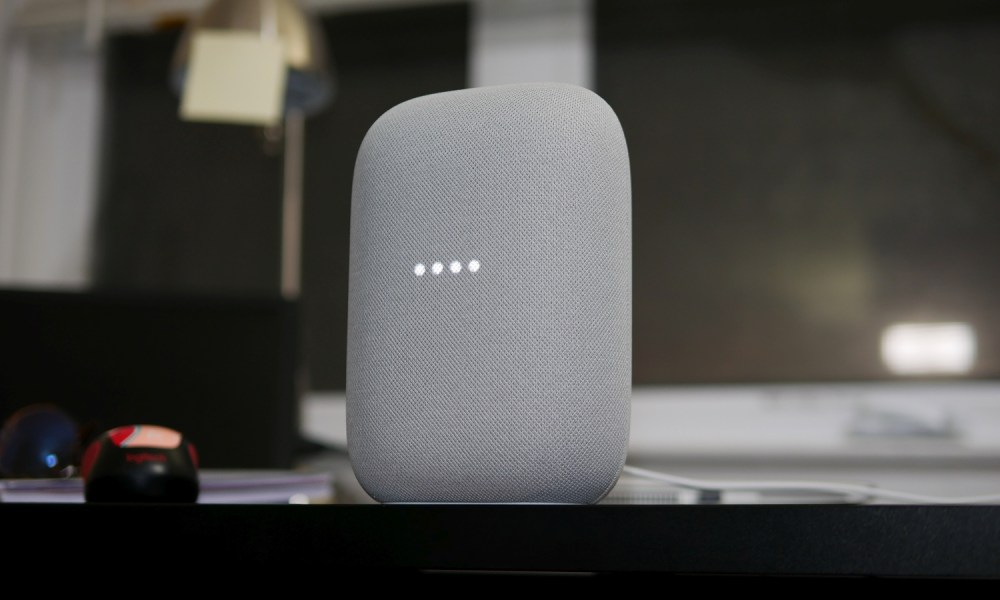 Nest Audio speaker in a moody dark room.