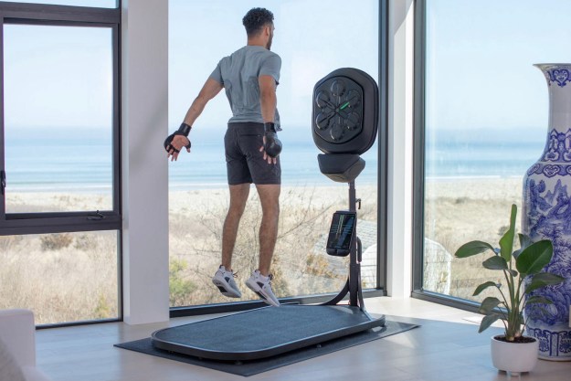 A man using a Liteboxer jumps during his workout.