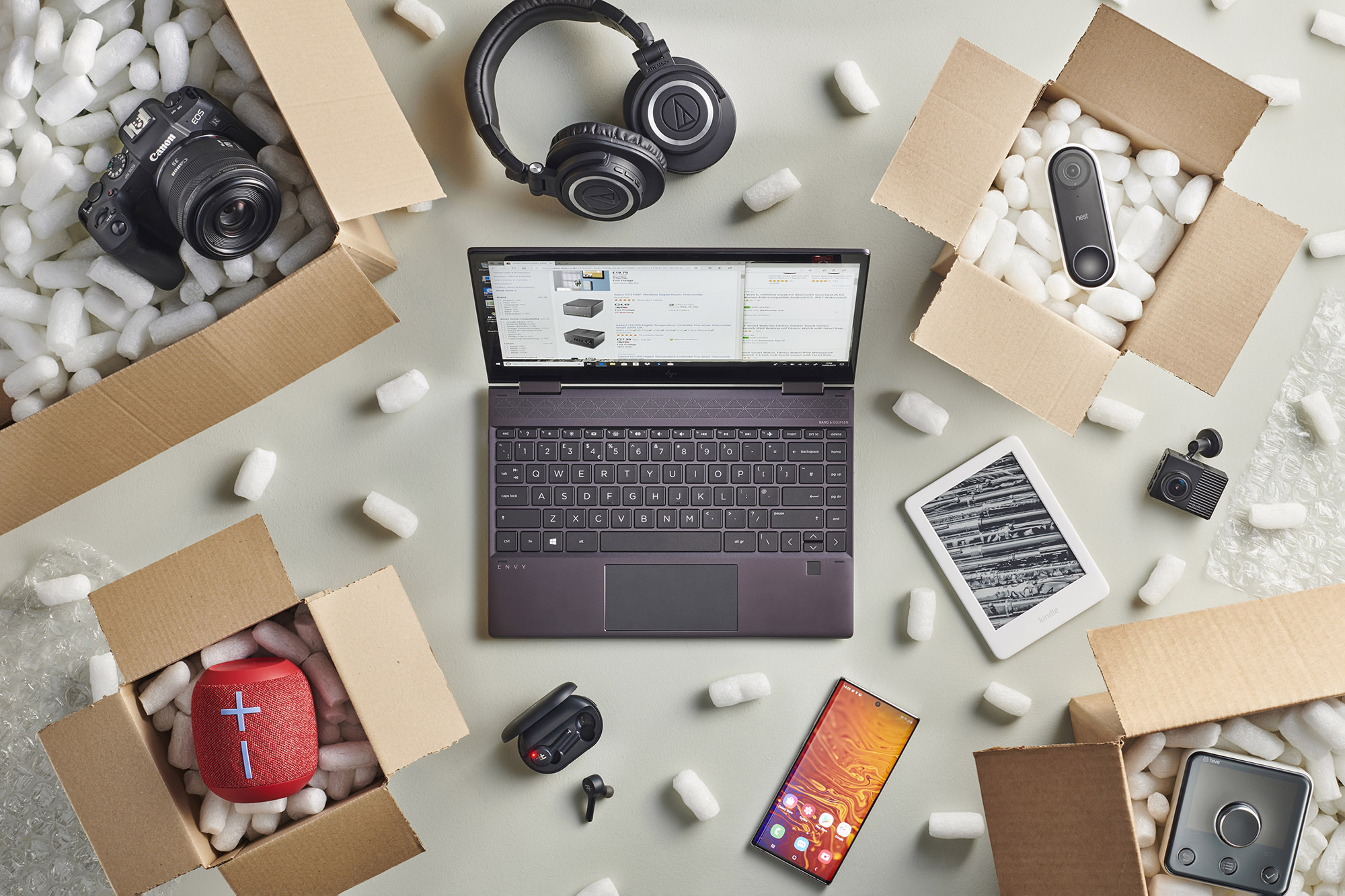 Laptop on Amazon surrounded by boxes of tech gear.