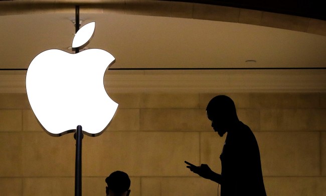 A man checks his phone in an Apple retail store in Grand Central Terminal.