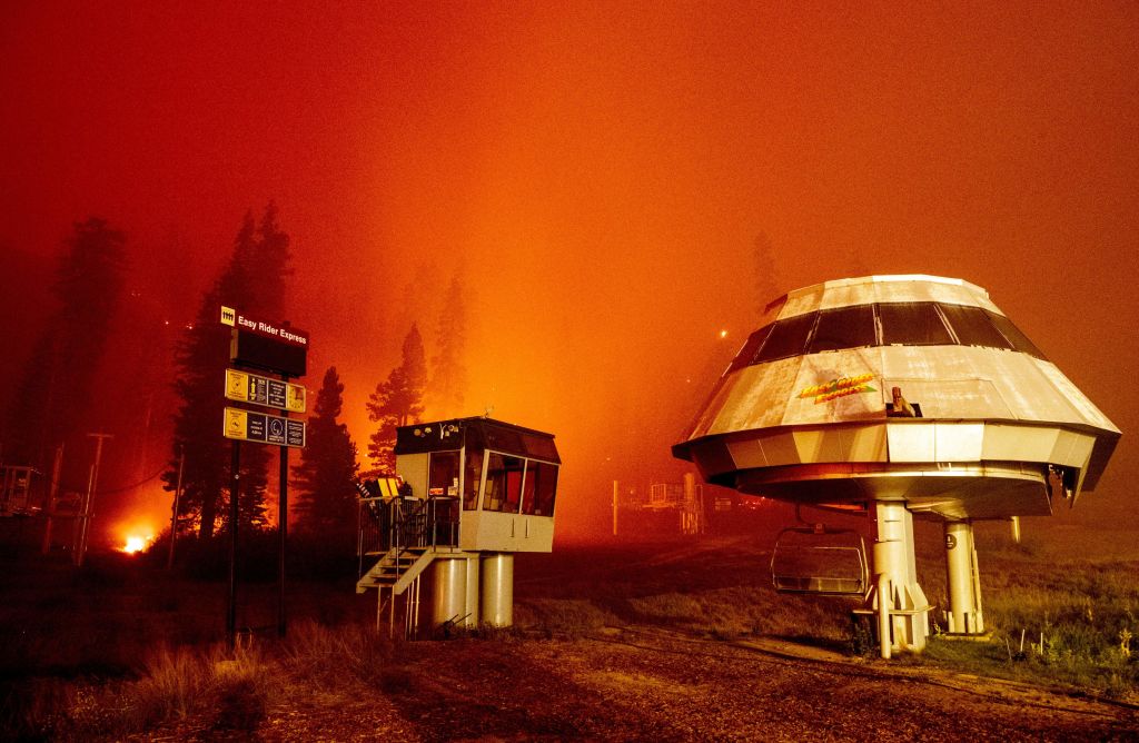 Flames from the Caldor Fire surround buildings at Sierra-at-Tahoe Resort.