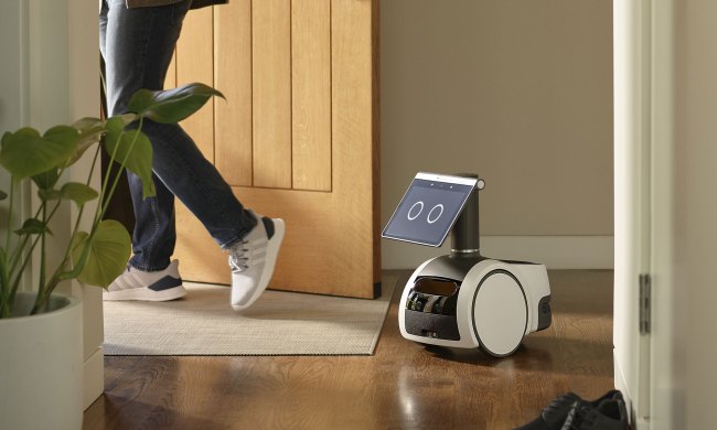 Amazon Astro following a person through a door.