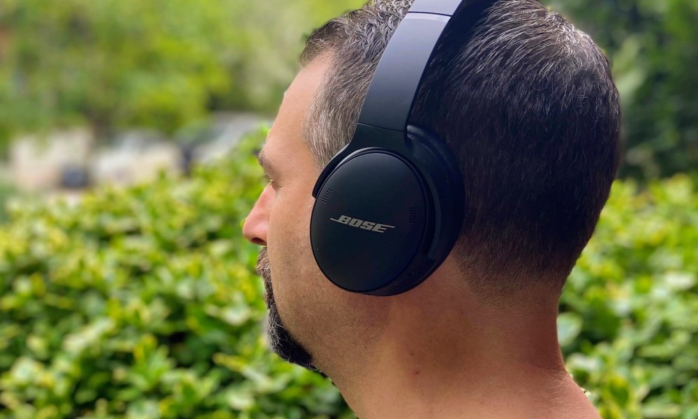 Man wearing Bose QuietComfort 45 noise-canceling headphones.