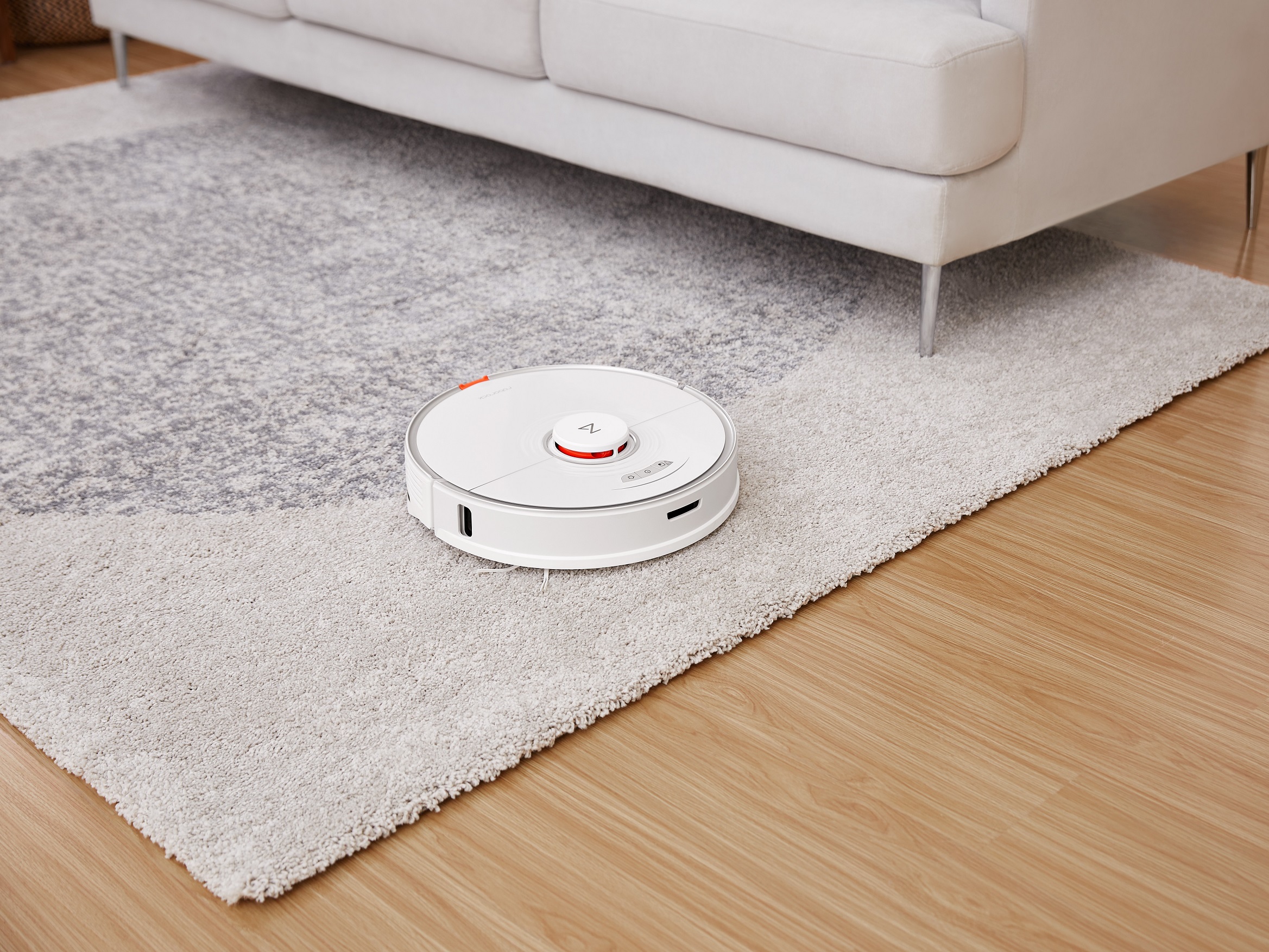 Roborock S7 vacuuming a carpet after raising the mop system.