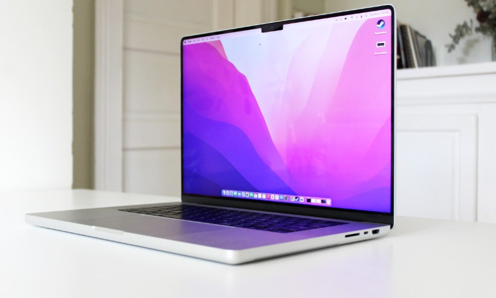 The 2021 MacBook Pro with the lid open on a white table.