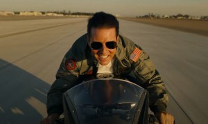 Tom Cruise rides a motorcycle in the wind in Top Gun: Maverick.