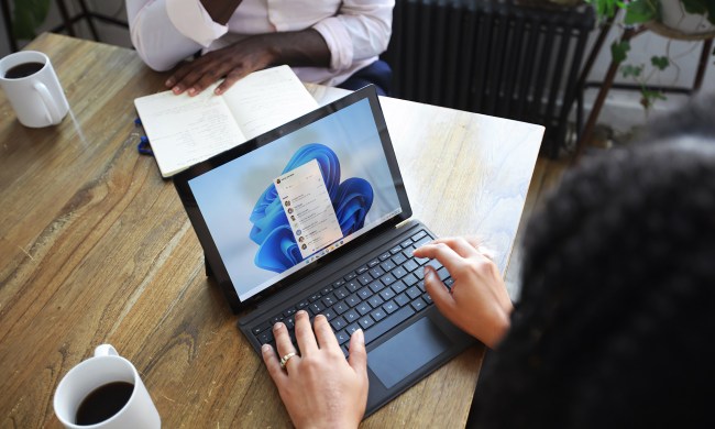 Person sitting and using a Windows Surface computer with Windows 11.