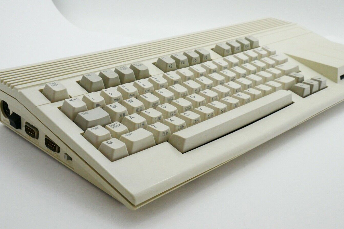 A working Commodore 65 PC with keyboard on a desk.