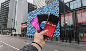 Hold holding three phones from three different carriers.