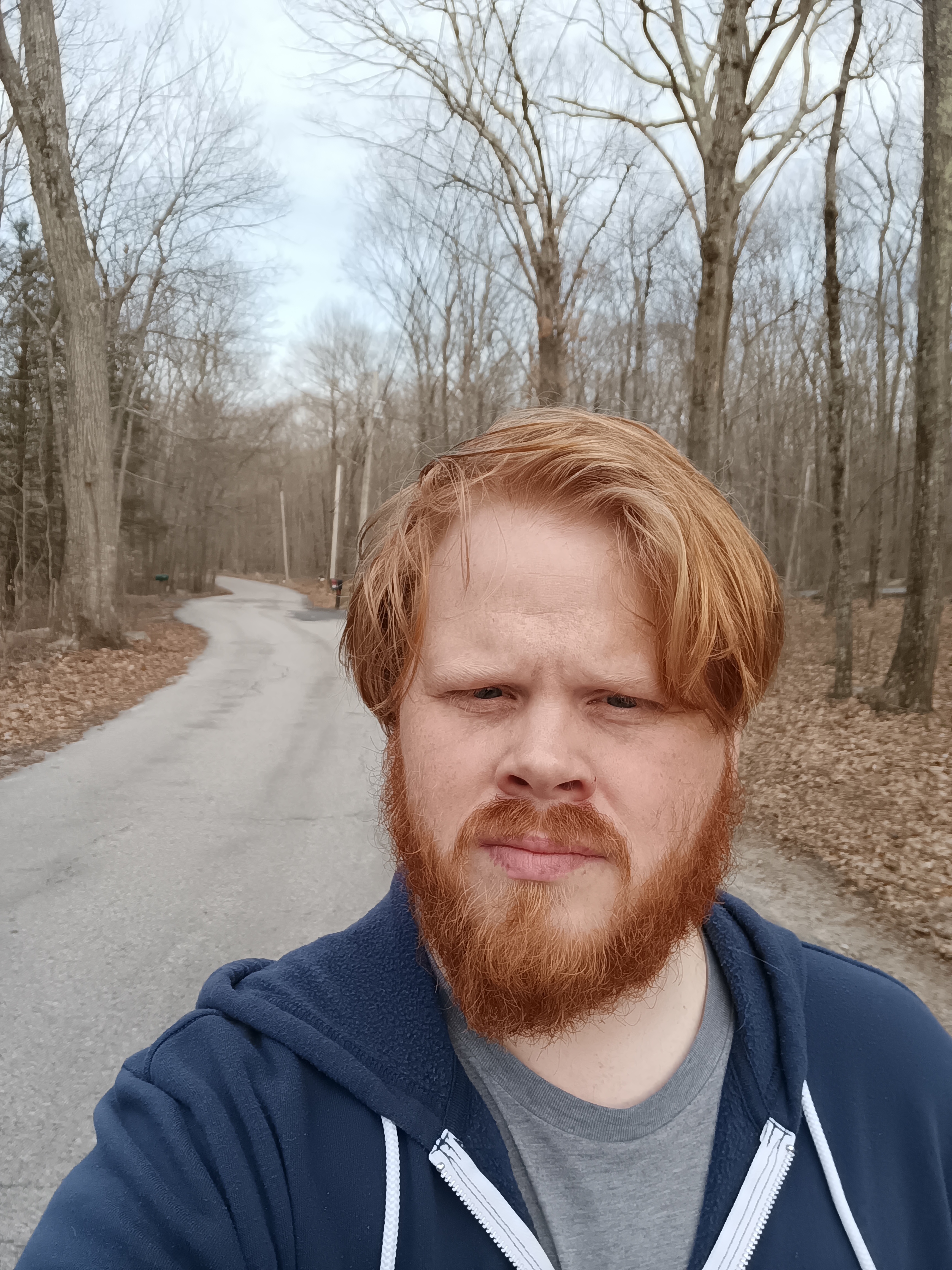 Selfie of a man on a road in the woods