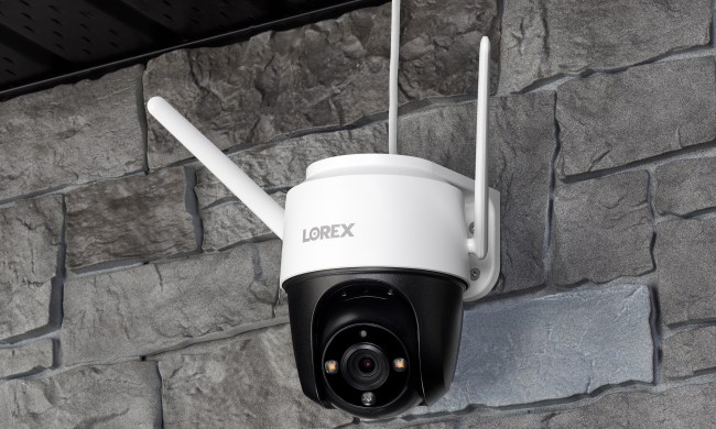 Lorex 2K Pan-Tilt WiFi Outdoor Security Camera mounted on stone wall.