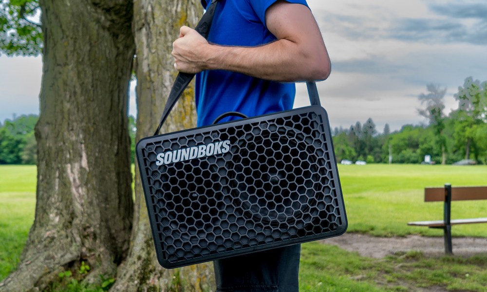 Soundboks Go with carrier strap on shouldder..