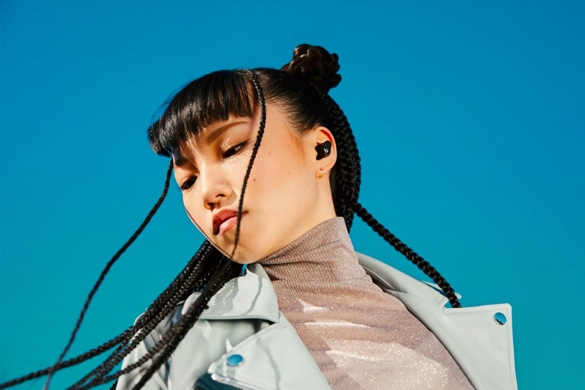 A woman listens to music on her Beats Studio Buds.