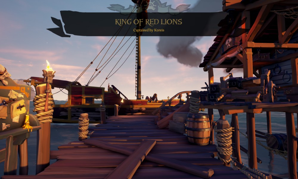 The name King of Red Lions floats above a red, customized ship in Sea of Thieves.