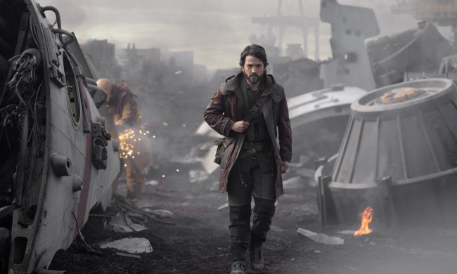 Diego Luna walks through a scrapyard of ships in a scene from Andor.