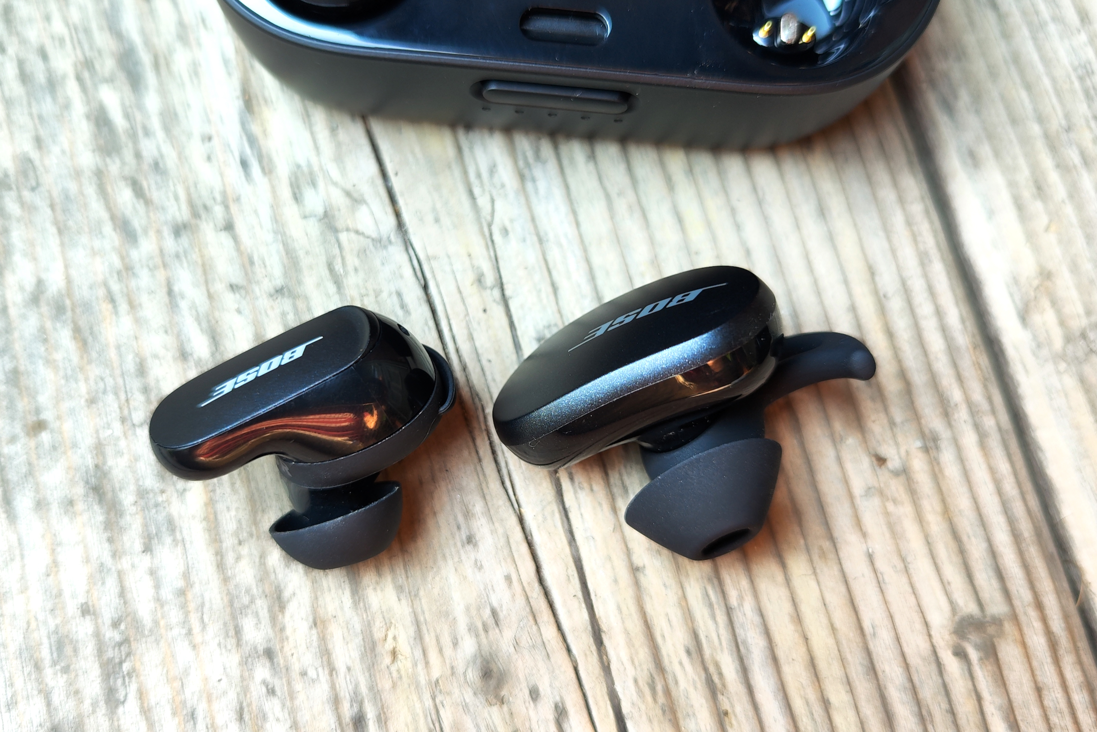 First and second-gen Bose QuietComfort Earbuds seen side-by-side.