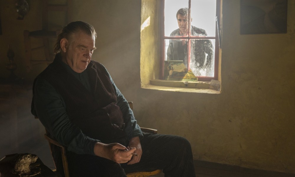 Colin Farrell looks through a window at Brendan Gleeson in The Banshees of Inisherin.