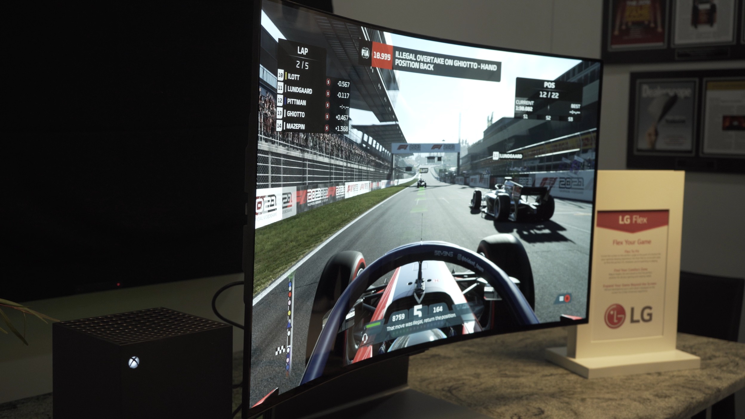 LG OLED Flex TV with racing game on screen, screen curved