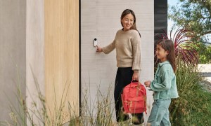 Someone presses the Nest Video Doorbell in front of their home.