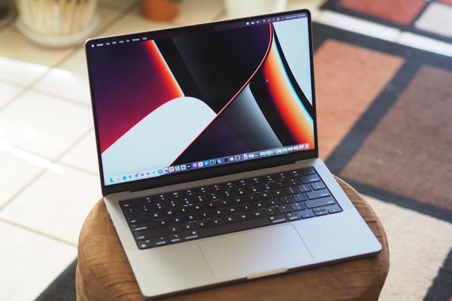 An Apple MacBook Pro 14 sits open on a table.