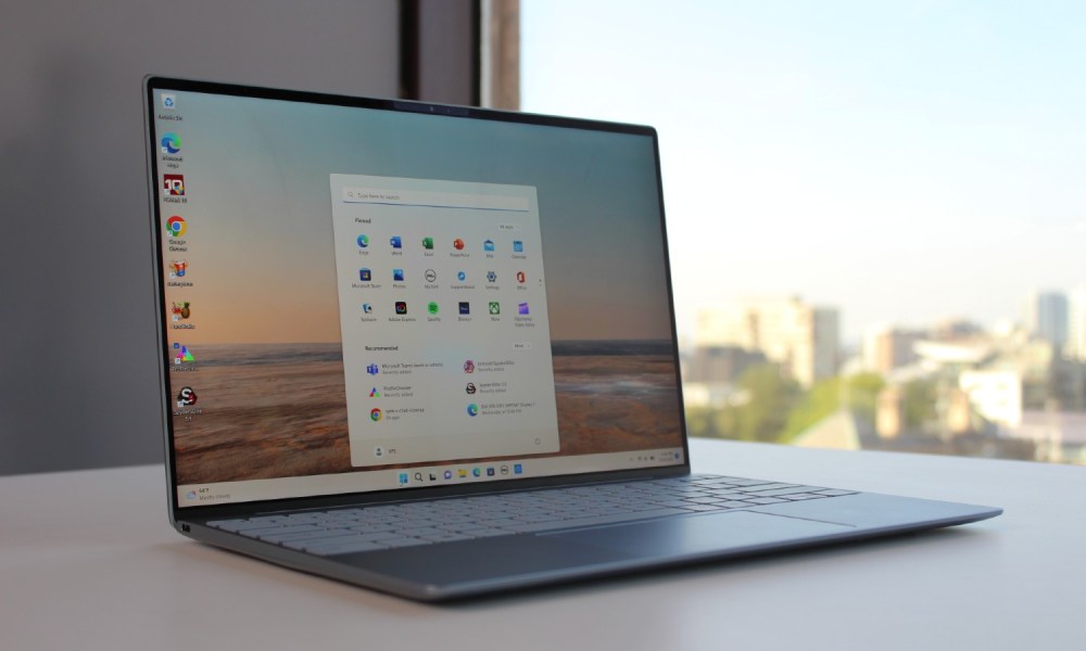 The Dell XPS 13 on a table with the Start Menu open.