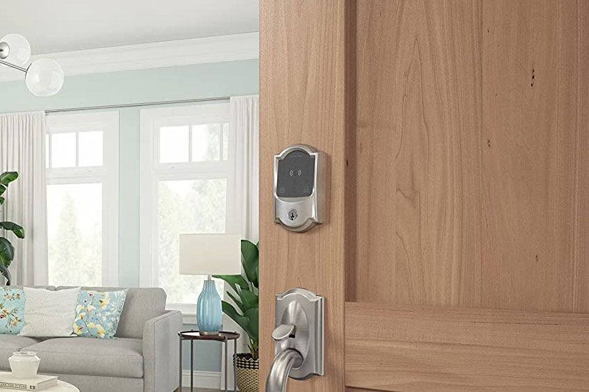 Schlage Encode Plus smart lock installed on a wooden door to a living room.