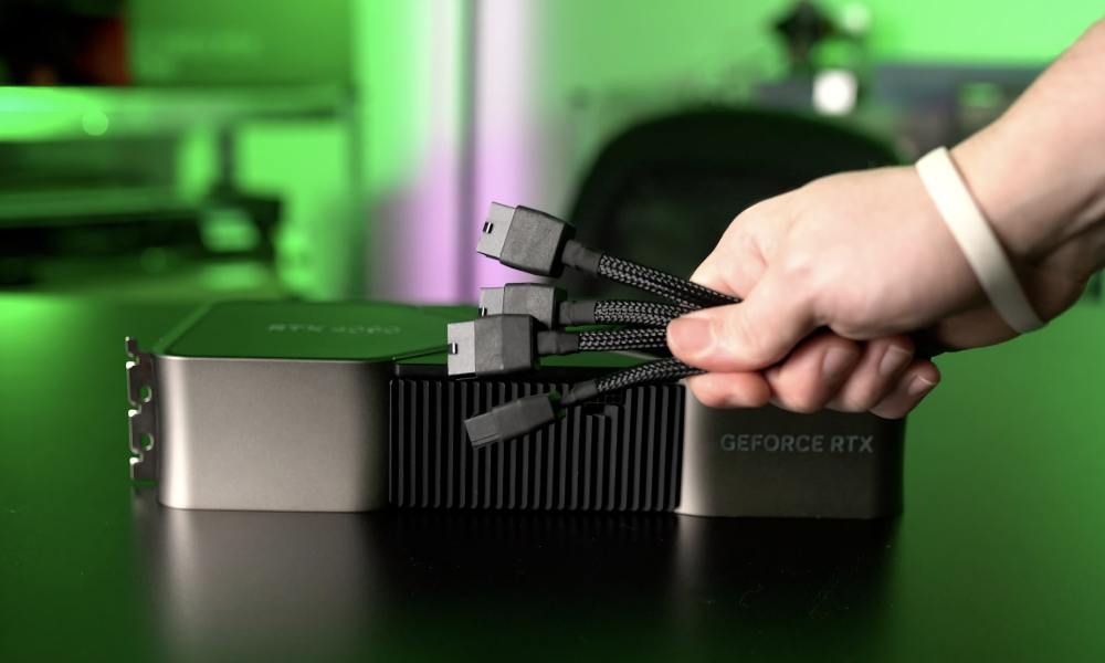 Nvidia GeForce RTX 4090 is shown along with a hand holding the power cable adapter.