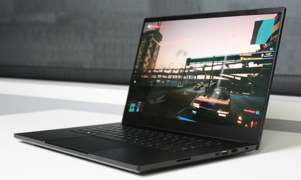 The Razer Blade 15 on a table with a game on the screen.