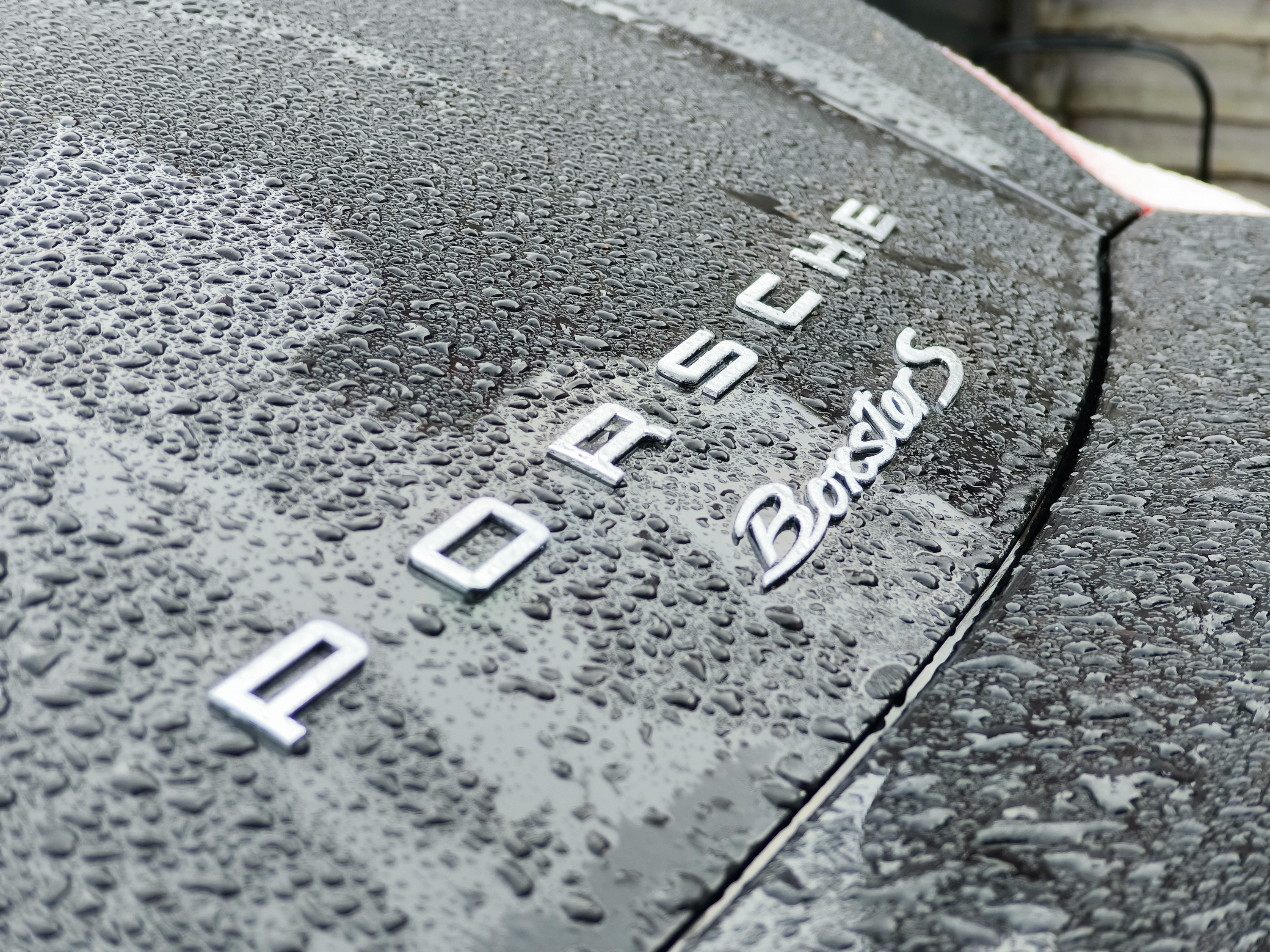 Phantom X2 Pro bokeh photo of a Porsche logo.