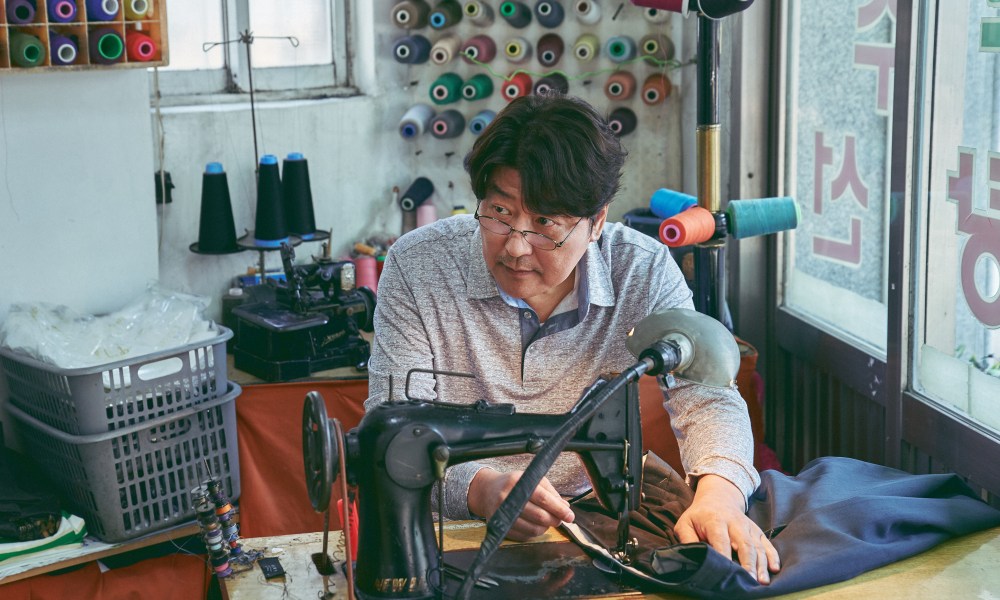 Song Kang-ho operates a sewing machine in Broker.