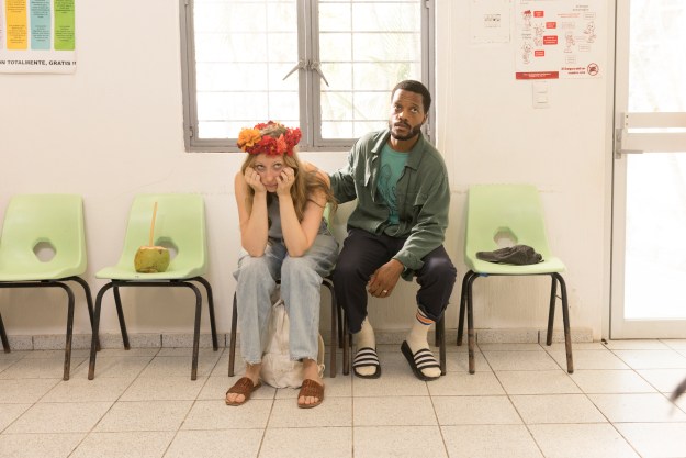 Anna Konkle and Jermaine Fowler sit in the waiting room of a hospital during a scene from The Drop.