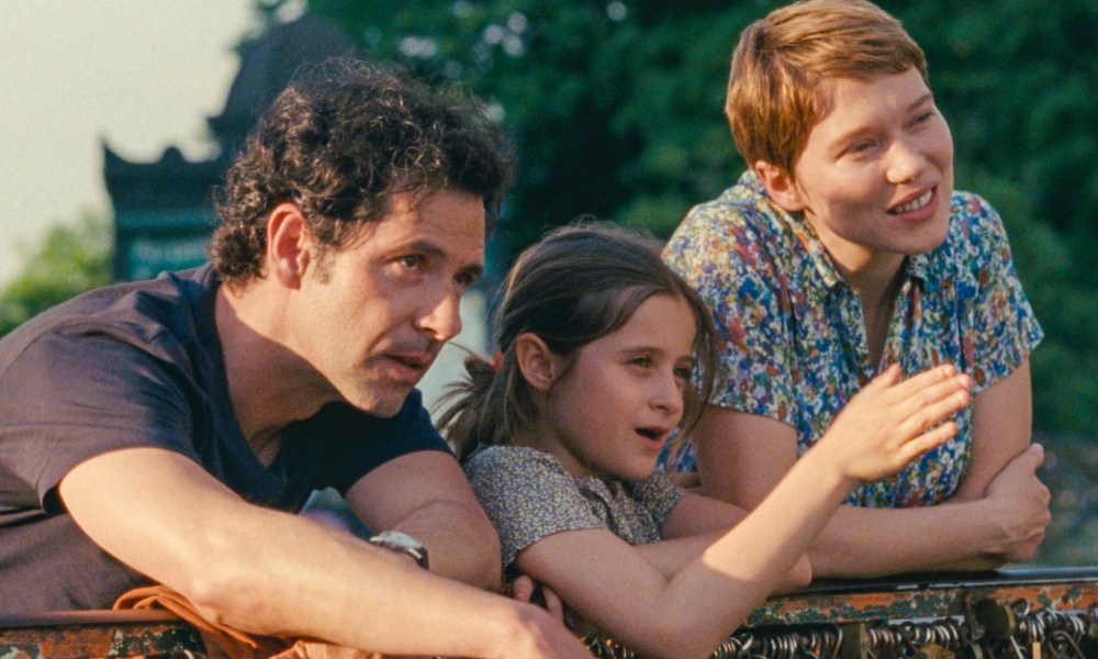 Melvil Poupaud, Camille Leban Martins, and Léa Seydoux lean on a railing together in One Fine Morning.